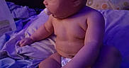 Ka'Marie is registered to the contest to win money with this photo: baby, infant, child, sitting, pacifier, diaper, bed, bedroom, blanket, bedding, portrait, profile, face, skin, head, arms, legs, indoor, purple_lighting, home