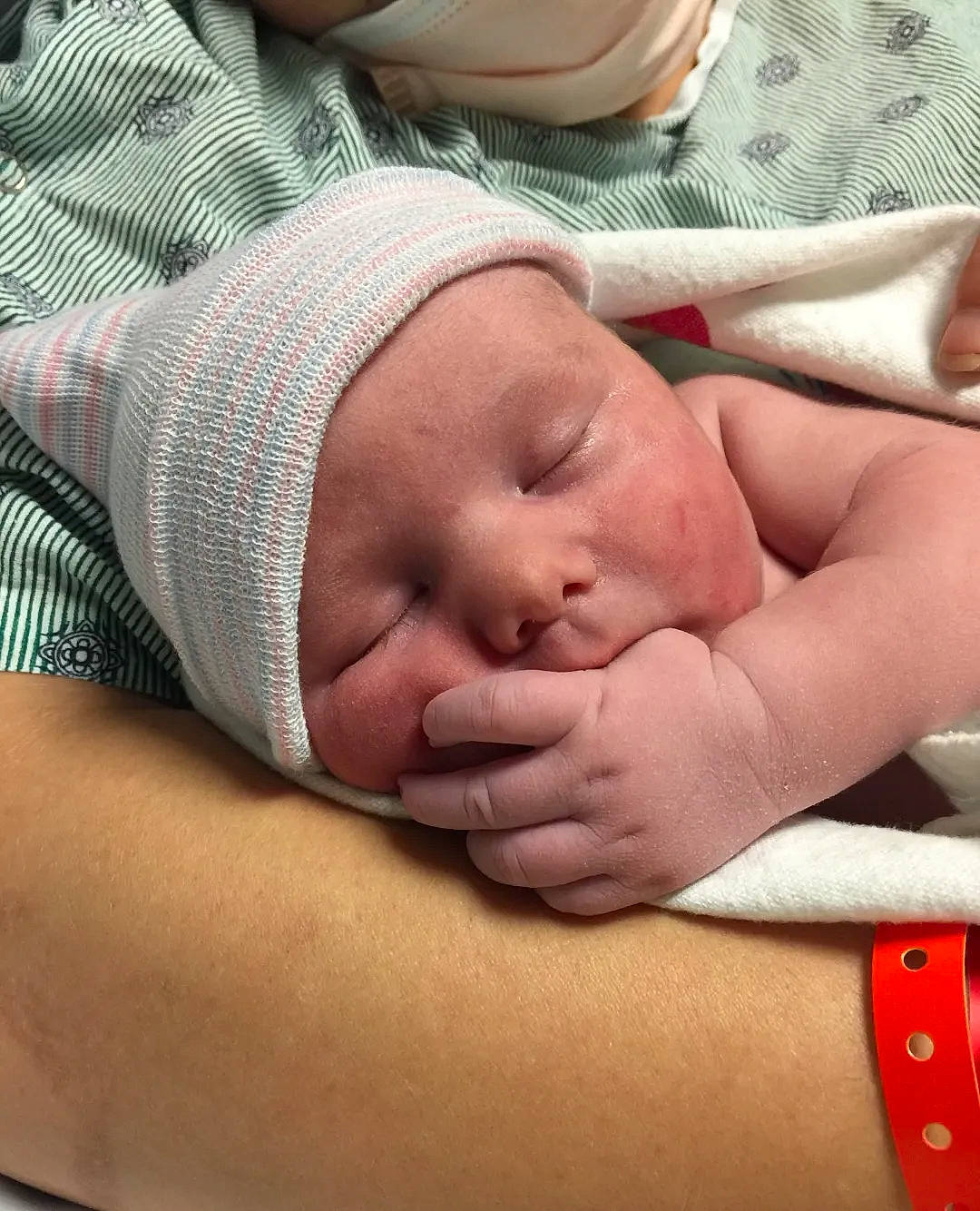 Ronald is registered to the contest to win money with this photo: abdomen, baby, baby_sleeping, child, childbirth, comfort, elbow, event, finger, flesh, headwear, hospital, linens, medical, pattern, person, room, service, skin, sleep