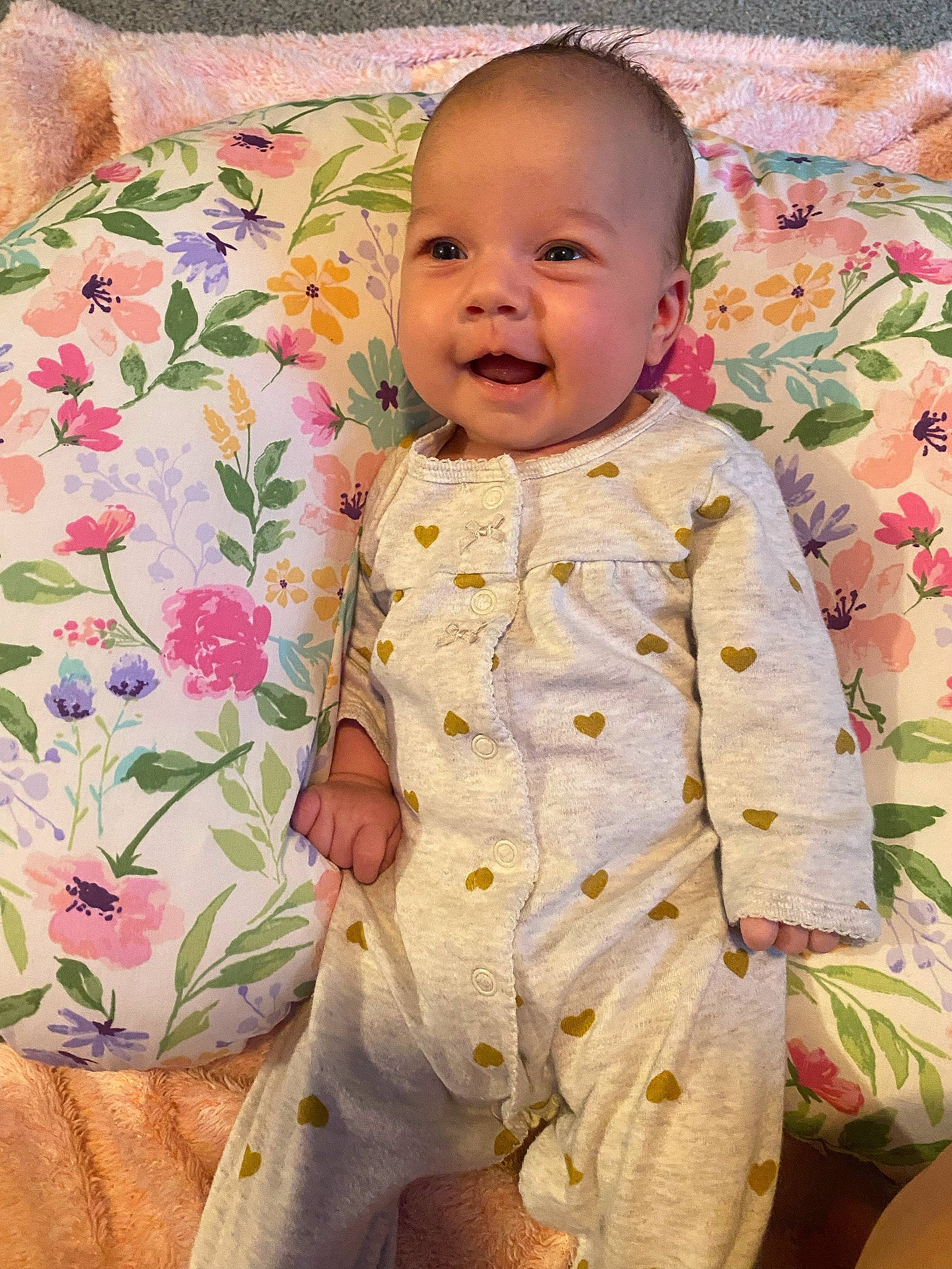 Ensleigh is registered to the contest to win money with this photo: baby, baby_toddler_clothing, bedding, cheek, child, comfort, dress_shirt, face, facial_expression, happy, linens, pattern, person, pink, room, skin, sleeve, smile, t_shirt, textile