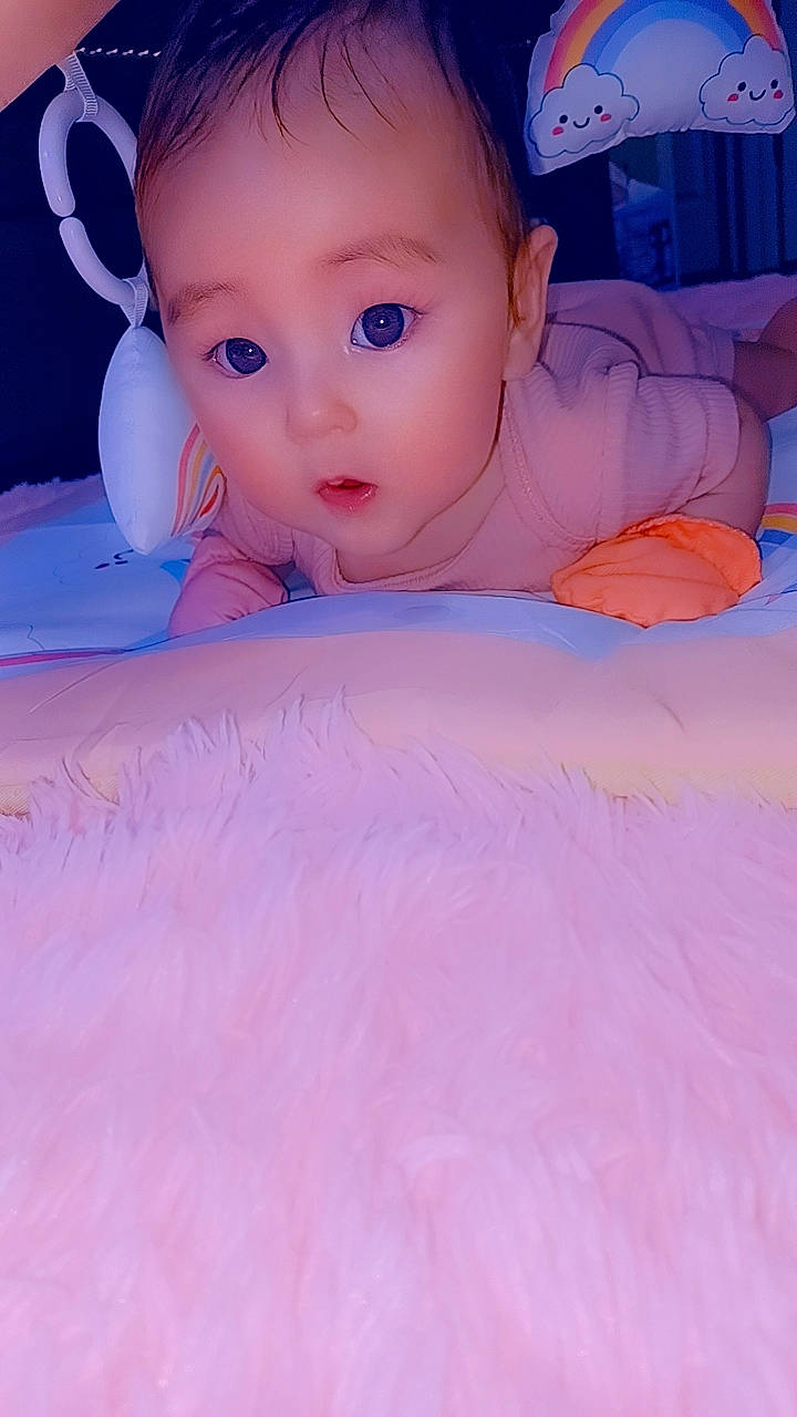 Ahri joined the competition — help win amazing prizes! baby, baby_toddler_clothing, bedding, cheek, child, comfort, electric_blue, eyebrow, finger, fun, iris, linens, magenta, person, pink, purple, skin, surprise, textile, thumb