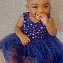 Aaliyah joined the competition — help win amazing prizes! toddler, child, smiling, braids, dress, stars_pattern, blue_dress, red_shoes, sitting, couch, happy, cute, indoor, portrait, young_child, playful, hand_near_mouth, fashion, casual, person