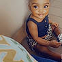 toddler, child, smiling, sitting, indoor, pigtails, hair_bows, black_top, leopard_print, shorts, socks, shoes, floor, tile_floor, cute, portrait, happy, young_child, baby, person