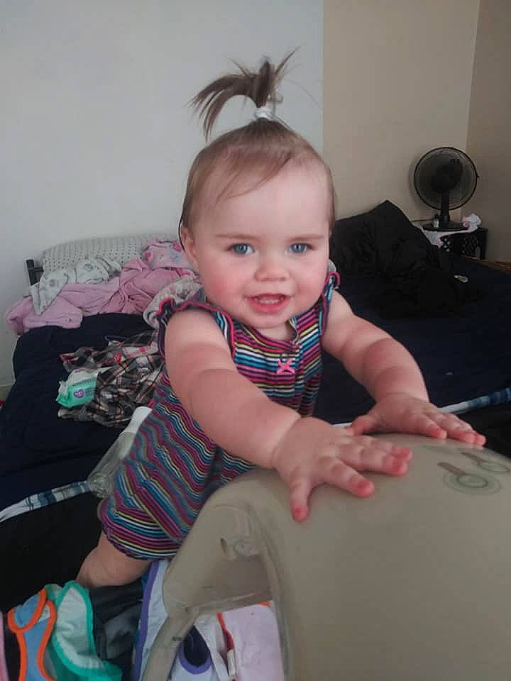 Aniya is registered to the contest to win money with this photo: baby, baby_toddler_clothing, cheek, child, comfort, eye, facial_expression, finger, fun, hairstyle, happy, human_leg, joint, knee, person, sitting, skin, smile, sock, thigh