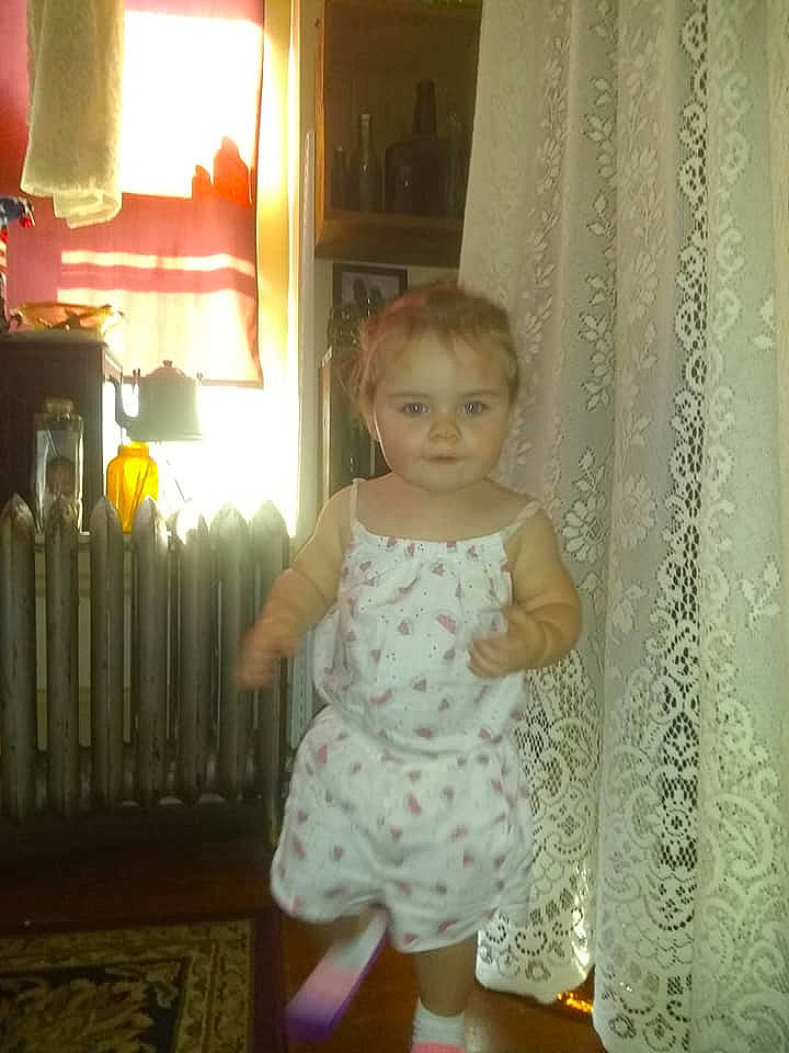 Aniya is registered to the contest to win money with this photo: baby, baby_toddler_clothing, beauty, child, curtain, day_dress, dress, flooring, fun, human_leg, knee, pattern, person, room, sleeve, standing, thigh, toddler, waist, window