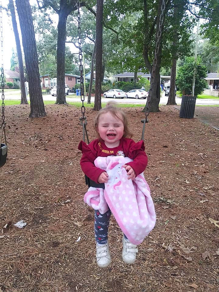 Aniya is registered to the contest to win money with this photo: baby, baby_toddler_clothing, car, city, fun, grass, happy, leaf, leisure, outdoor_play_equipment, people_in_nature, person, plant, playground, recreation, sleeve, smile, soil, sorrow, swing