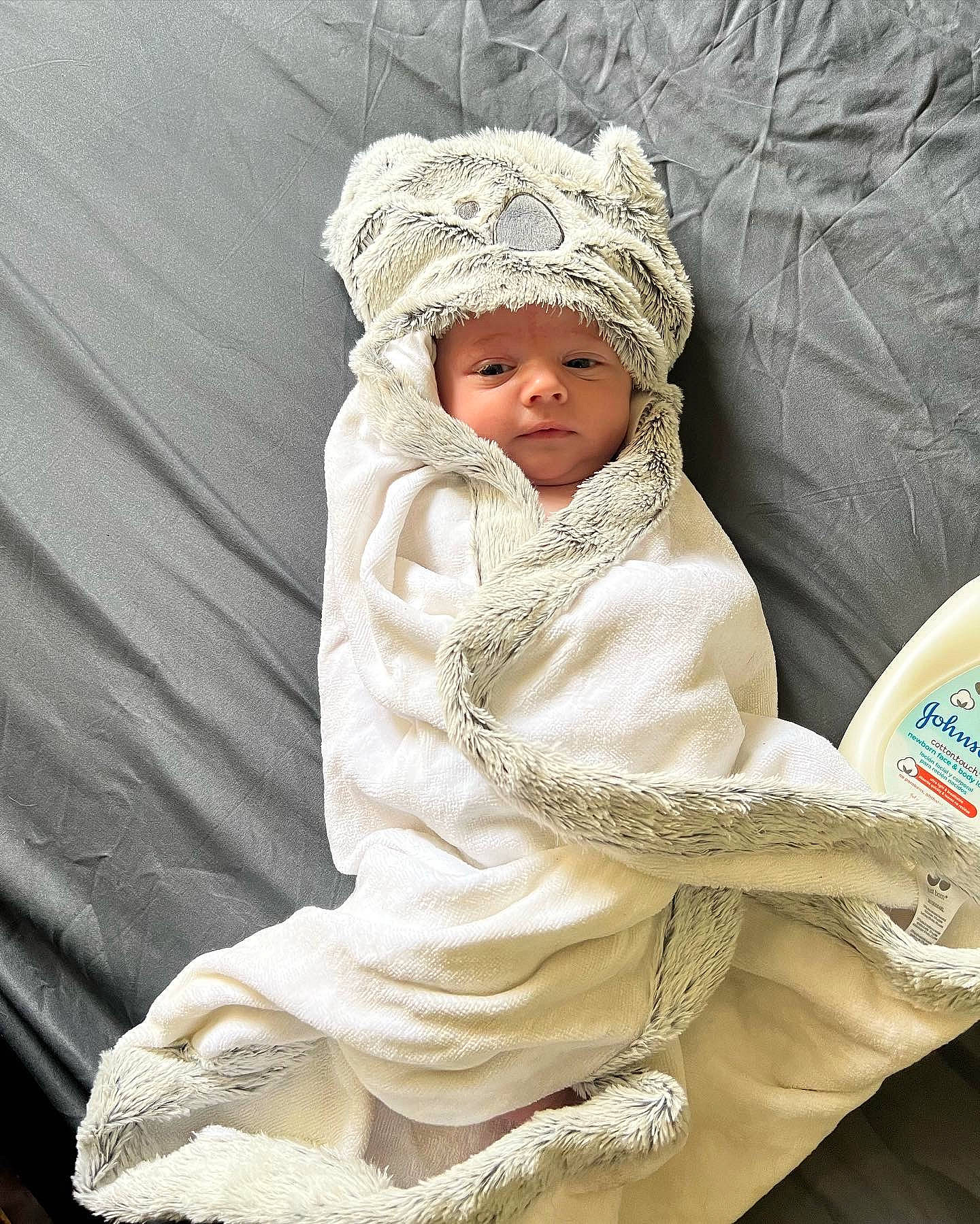 Briar is registered to the contest to win money with this photo: baby, baby_products, baby_sleeping, baby_toddler_clothing, beige, cap, cheek, child, comfort, fashion_accessory, grass, headgear, headwear, knit_cap, linens, outerwear, person, product, sitting, sleeve