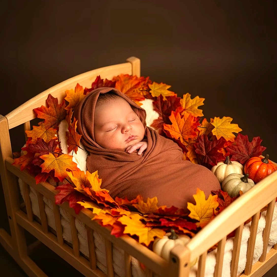Neteyam joined the competition — help win amazing prizes! autumn_leaves, baby, brown_wrap, cozy, cute, cute_baby, decor, fall_theme, indoor, infant, newborn, peaceful, portrait, pumpkins, seasonal, sleeping, soft_lighting, swaddled, wooden_bed, wrapped