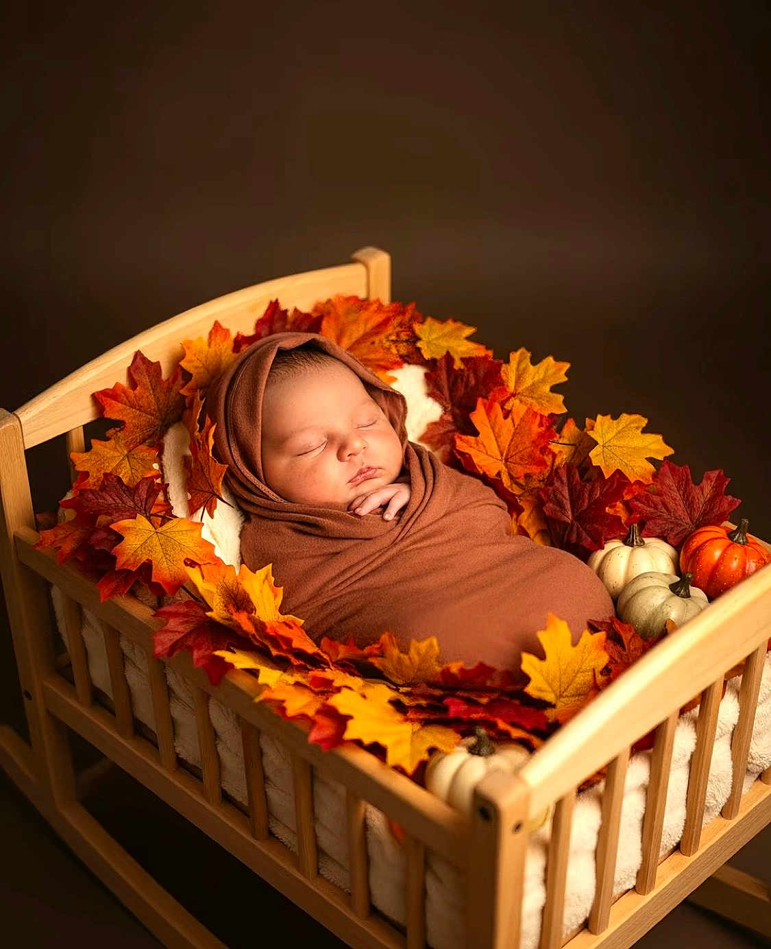 Neteyam joined the competition — help win amazing prizes! baby, sleeping, swaddled, wooden_bed, autumn_leaves, pumpkins, fall_theme, cozy, wrapped, infant, decor, brown_wrap, peaceful, cute, portrait, newborn, indoor, soft_lighting, seasonal, cute_baby