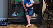John joined the competition — help win amazing prizes! barefoot, blue_outfit, boy, cabinet, chair, child, clothing, family_photo, glass_door, home, indoors, living_room, portrait, shoes, shorts, smiling, standing, table, toddler, wooden_floor