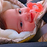 Marie Carmen participe au concours pour gagner de l'argent avec cette photo : baby, car_seat, child, closeup, cozy, cute, face, fuzzy, headwear, indoor, infant, jacket, pacifier, pink, portrait, seatbelt, smile, soft_texture, warm_clothing, young_child