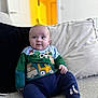 Lorenzo joined the competition — help win amazing prizes! baby, child, sitting, couch, sweater, animal_design, indoor, cute, portrait, child_clothing, soft_furniture, home, cozy, knitwear, infant, long_pants, black_socks, face, person, relaxed