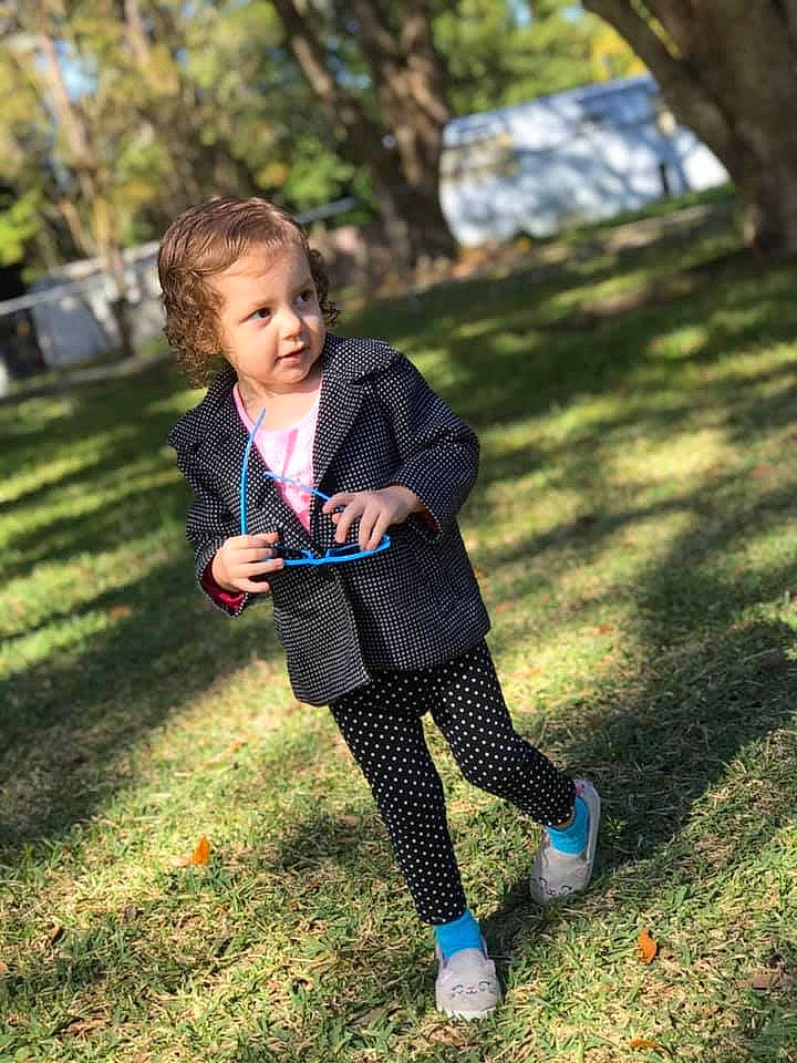 Thalia is registered to the contest to win money with this photo: beauty, child, child_model, design, footwear, grass, happy, leggings, outerwear, pattern, person, photograph, photography, plaid, play, shoe, smile, spring, tights, toddler