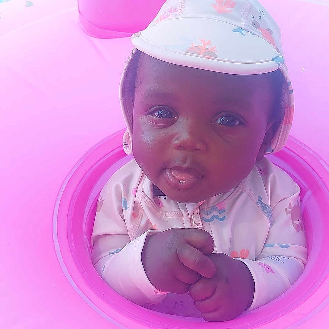 Psams-Marie joined the competition — help win amazing prizes! baby, child, clothing, cute, expression, face, hands, hat, infant, inflatable, outdoor, pink, playful, pool, portrait, skin, summer, swim_ring, water_toy, young