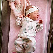 Ellie is registered to the contest to win money with this photo: newborn, baby, infant, sleeping, pink_blanket, hospital_bassinet, plush_toy, headband, onesie, baby_slippers, koala_pattern, soft_toy, sleep, child, person, cute, infant_clothing, baby_bedding, hospital, pink