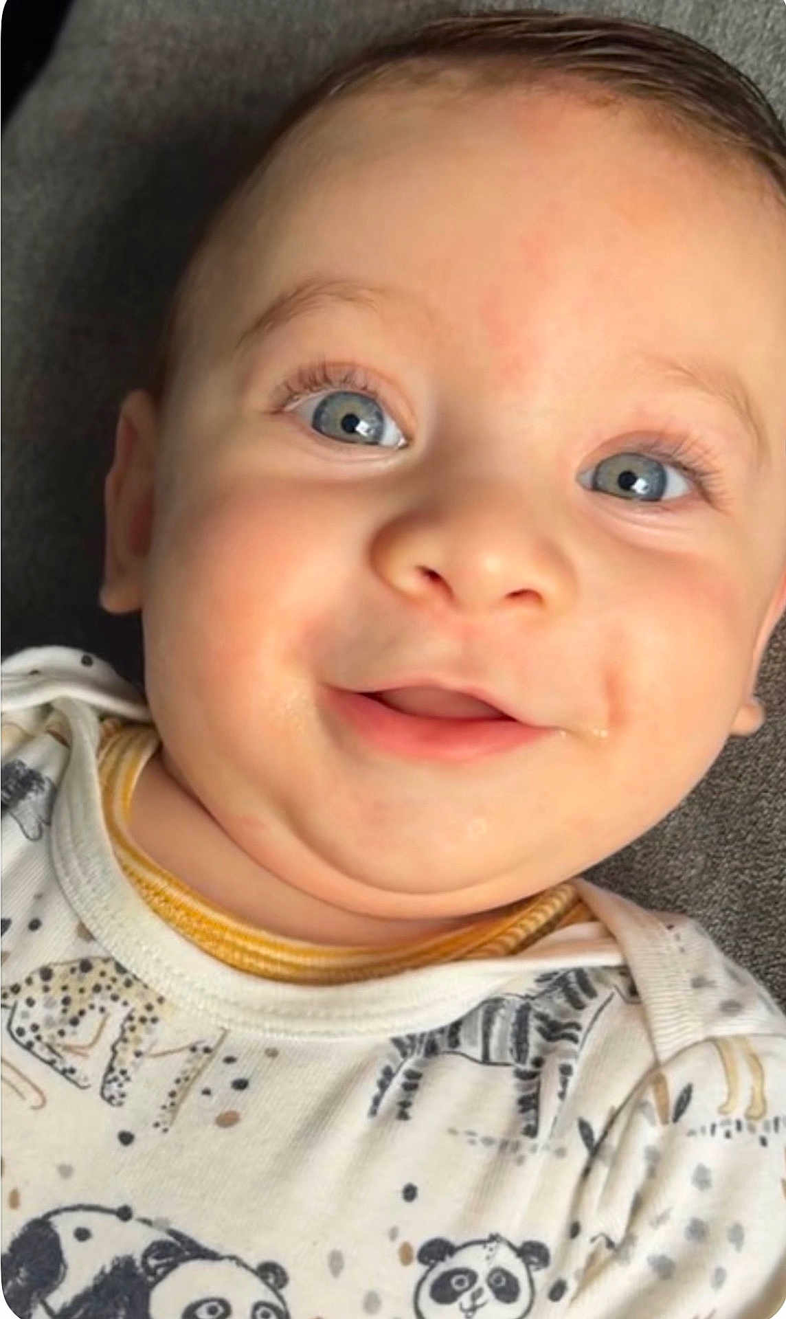 Zaid joined the competition — help win amazing prizes! baby, child, face, blue_eyes, smile, onesie, animal_print, panda, leopard, zebra, cute, close_up, infant, portrait, happy, skin, soft_lighting, cheeks, young, expression