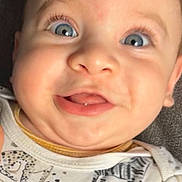 Zaid is registered to the contest to win money with this photo: baby, child, face, blue_eyes, smile, cute, onesie, animal_print, panda, zebra, portrait, infant, closeup, happy, expression, light_skin, clothing, soft_background, indoor, young_child