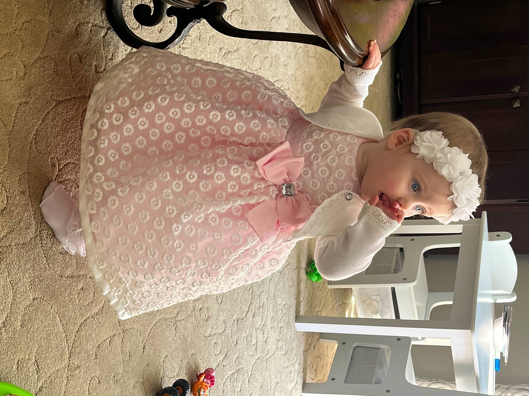 London is registered to the contest to win money with this photo: baby, baby_products, baby_toddler_clothing, child, dress, eyelash, fashion_accessory, hat, headwear, jewellery, pattern, person, room, surprise, tableware, toddler, wrist