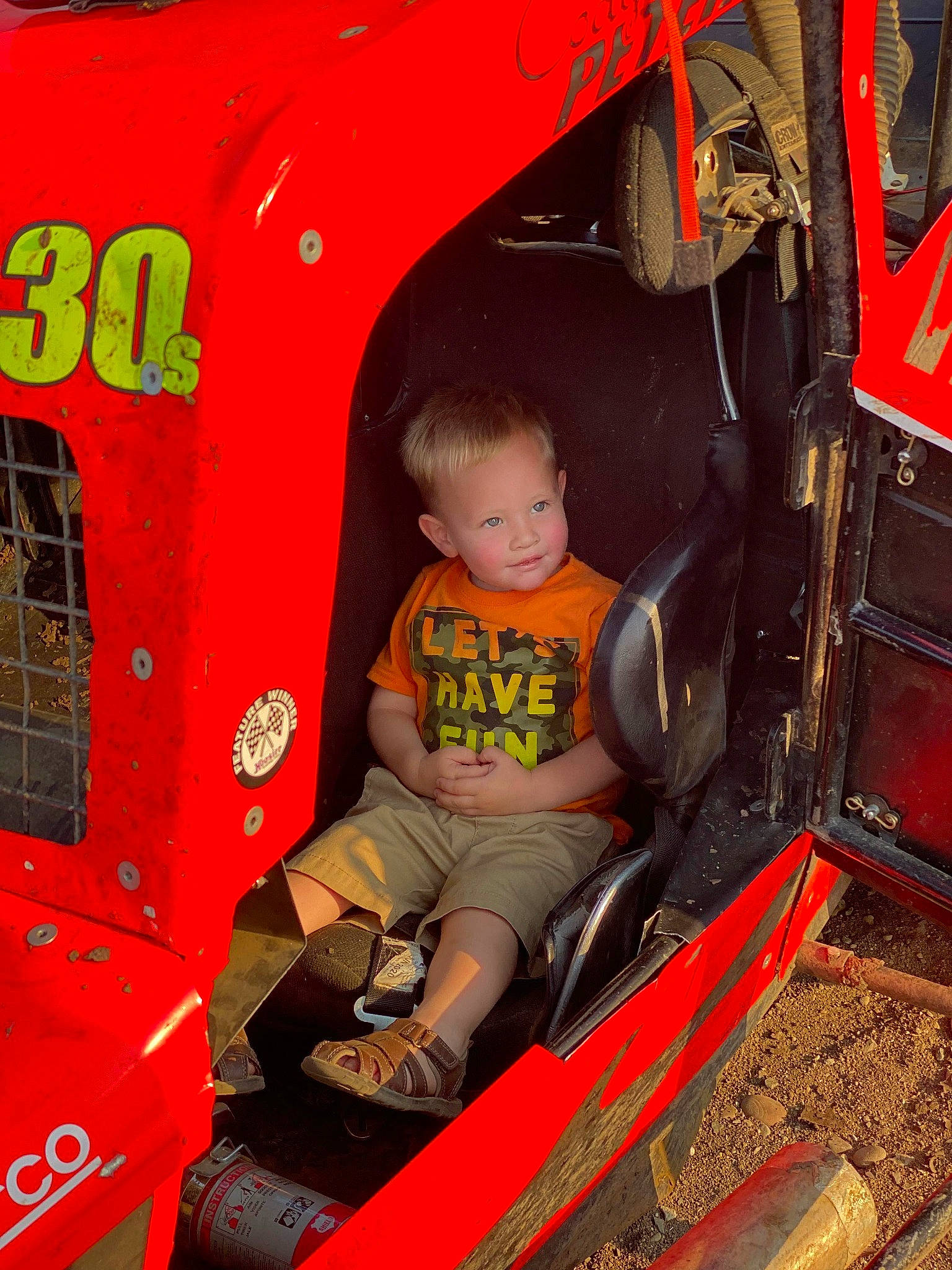 Lucca Buck-roberts is registered to the contest to win money with this photo: auto_part, automotive_design, automotive_exterior, automotive_tire, automotive_wheel_system, bumper, child, fender, fun, joy, machine, motor_vehicle, person, play, playground, public_space, recreation, red, t_shirt, toddler