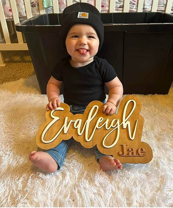 Evaleigh joined the competition — help win amazing prizes! baby, baby_toddler_clothing, baseball_cap, cap, child, comfort, facial_expression, floor, flooring, font, fun, happy, hardwood, headwear, joy, person, sitting, sleeve, smile, t_shirt