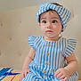 Minha joined the competition — help win amazing prizes! baby, child, girl, infant, sitting, blue_and_white_stripes, headband, dress, patterned_blanket, indoors, curious_expression, cute, small_hands, white_socks, soft_lighting, portrait, face, young, adorable, seated