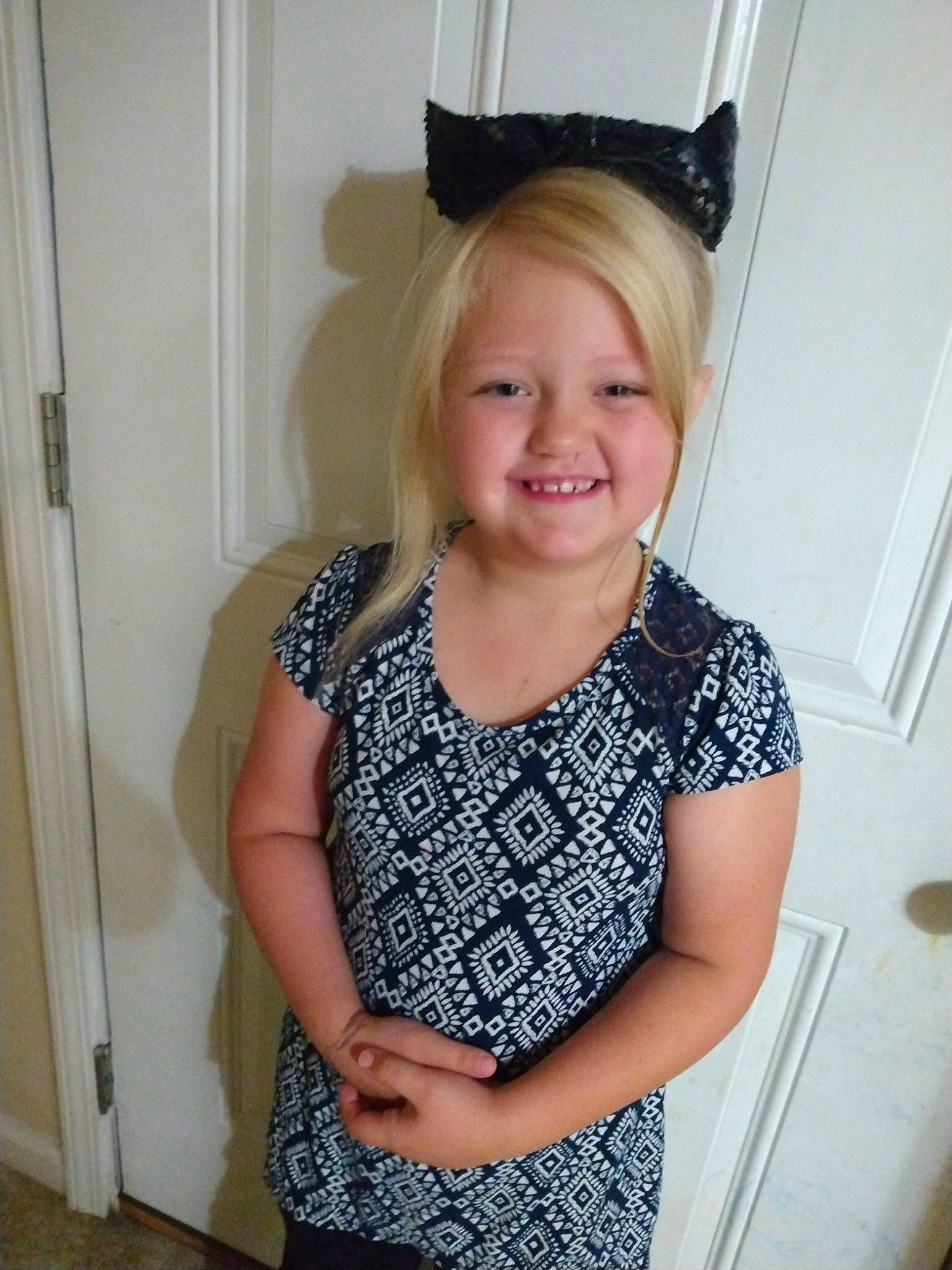 Zoey joined the competition — help win amazing prizes! blond, day_dress, door, electric_blue, fashion_accessory, fashion_design, formal_wear, gesture, happy, iris, jewellery, joint, joy, neck, pattern, person, shoulder, sleeve, smile, t_shirt