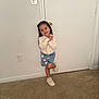 Arlenis joined the competition — help win amazing prizes! child, girl, smiling, standing, door, white_wall, carpet, sneakers, denim_skirt, hearts, sweater, long_hair, indoor, playful, pose, clothing, footwear, home, casual, cute