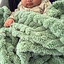 baby, infant, blanket, green_blanket, cozy, wrapped, soft_texture, face, curious_eyes, cute, child, newborn, warm, comfort, indoor, portrait, sitting, clothing, hand, head