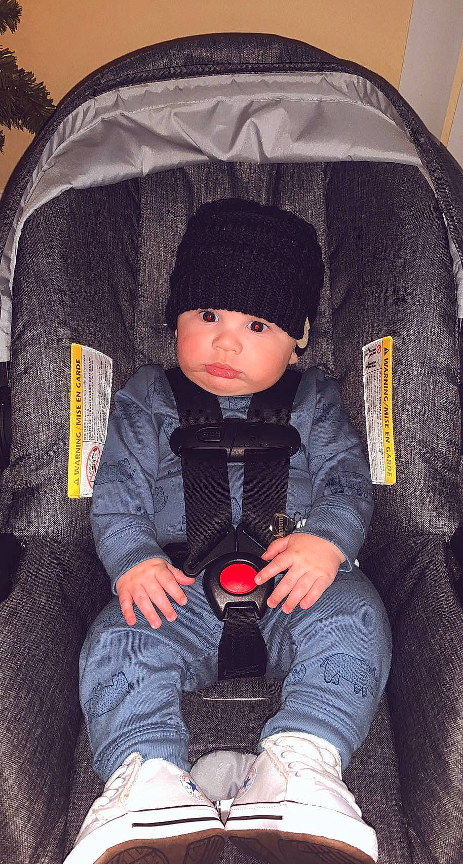 Fabian joined the competition — help win amazing prizes! baby, baby_carriage, baby_products, baby_toddler_clothing, beanie, black, car_seat, chair, cheek, comfort, fashion_accessory, flash_photography, headwear, human_leg, outerwear, people, person, sitting, sleeve, textile