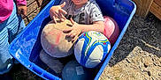Grayson is registered to the contest to win money with this photo: blue_bin, boy, brick_wall, casual_clothing, child, grass, hand_gesture, jeans, outdoor, person, pink_shirt, play_ball, playful, recreation, shadow, smile, soccer_ball, sunlight, toy, wooden_fence