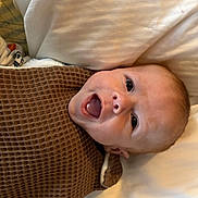 Mason joined the competition — help win amazing prizes! baby, smiling, blanket, brown_blanket, infant, face, happy, lying_down, pillow, closeup, cute, child, person, indoors, skin, head, expression, mouth_open, newborn, cozy