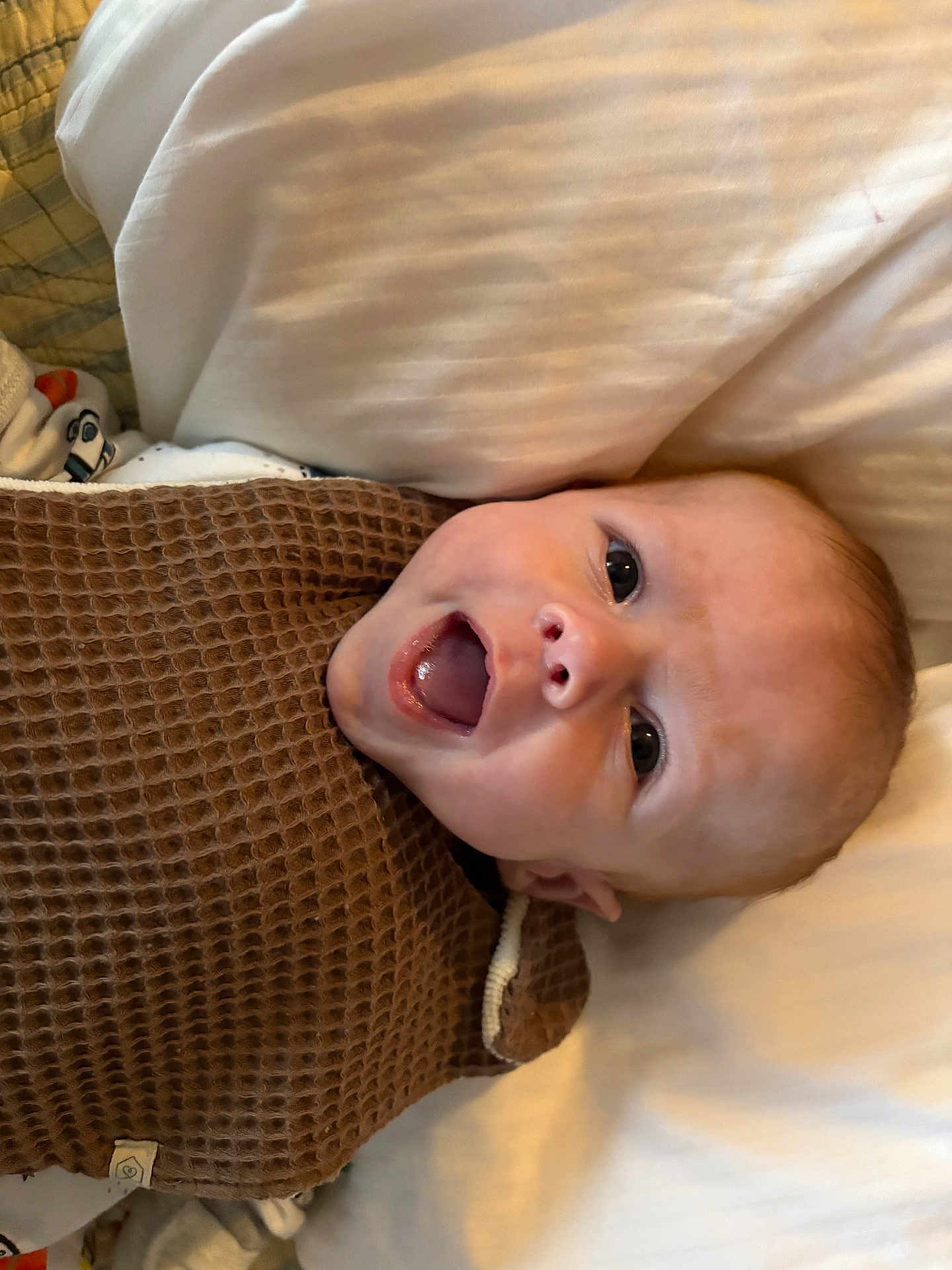 Mason joined the competition — help win amazing prizes! baby, smiling, blanket, brown_blanket, infant, face, happy, lying_down, pillow, closeup, cute, child, person, indoors, skin, head, expression, mouth_open, newborn, cozy