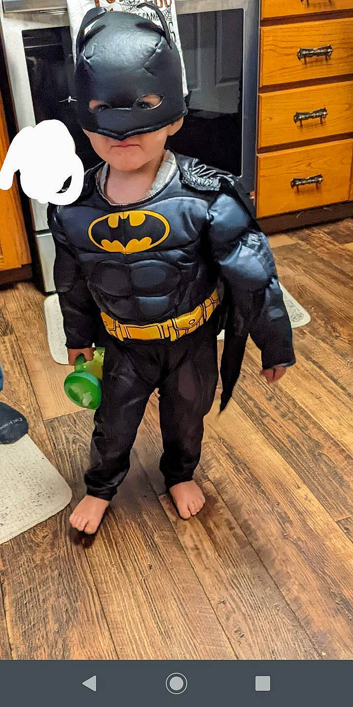 Luke Hayden is registered to the contest to win money with this photo: action_figure, animation, batman, cabinetry, child, cosplay, costume, drawer, fiction, fictional_character, figurine, flooring, hardwood, hero, justice_league, mascot, person, personal_protective_equipment, sunglasses, superhero