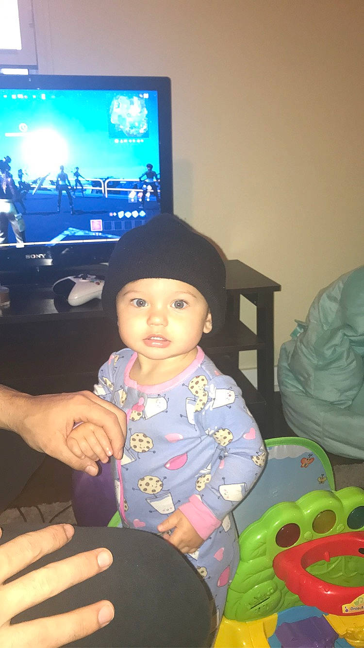 Nella is registered to the contest to win money with this photo: baby, baby_products, baby_toddler_clothing, baby_toys, display_device, finger, flat_panel_display, hand, headwear, human, lap, lcd_tv, led_backlit_lcd_display, multimedia, nail, person, sitting, television, television_accessory, television_set