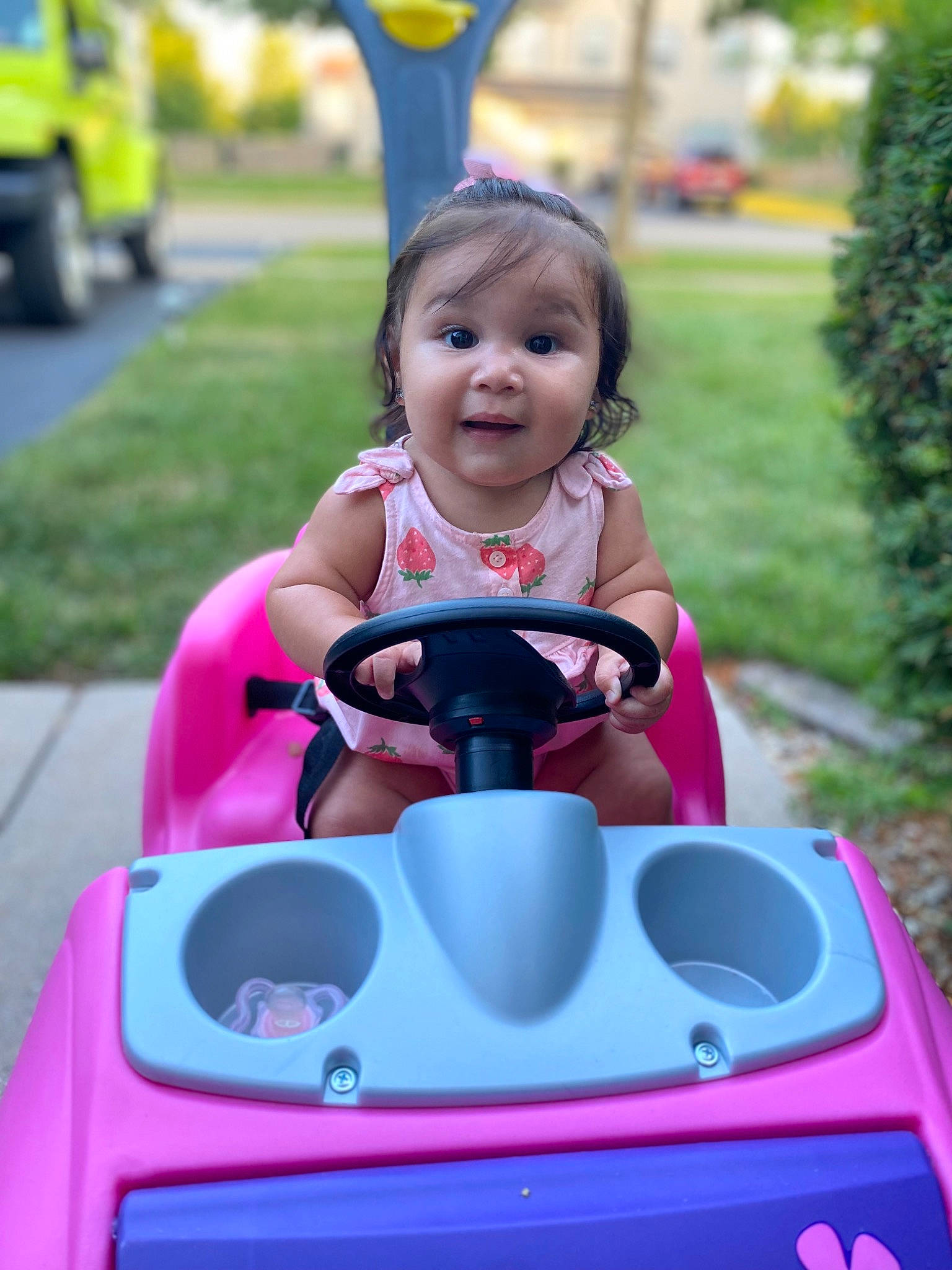 Evelynn joined the competition — help win amazing prizes! baby, fun, grass, green, happy, leisure, outdoor_recreation, person, photograph, pink, product, purple, red, riding_toy, tire, toddler, travel, vehicle, wheel, white