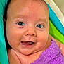 baby, infant, smiling, blue_eyes, purple_towel, towel, bathtub, bath_time, wet_skin, close_up, portrait, cute, chubby_cheeks, tiny_smile, eyelashes, skin, head, shoulder, happy, playful