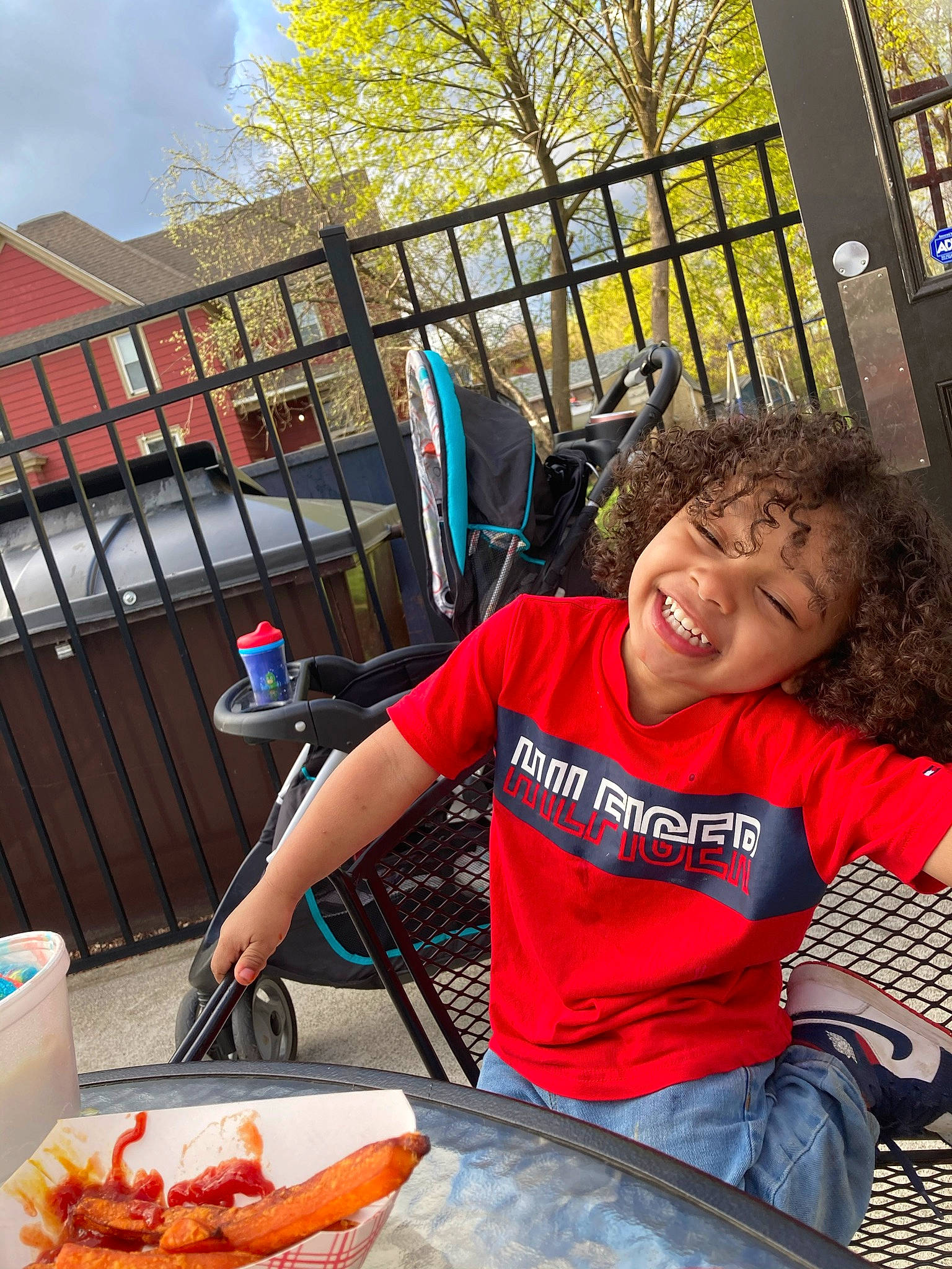 Anton is registered to the contest to win money with this photo: chair, cooking, cuisine, dish, food, fun, happy, joy, leisure, person, plate, public_space, recreation, sitting, sky, smile, t_shirt, table, tableware, travel