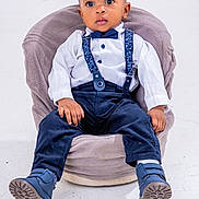 Yannick Blessing is registered to the contest to win money with this photo: accessories, boy, chair, child, clothing, face, footwear, formalwear, furniture, head, jeans, longsleeve, male, pants, person, photography, portrait, shoe, sitting, tie