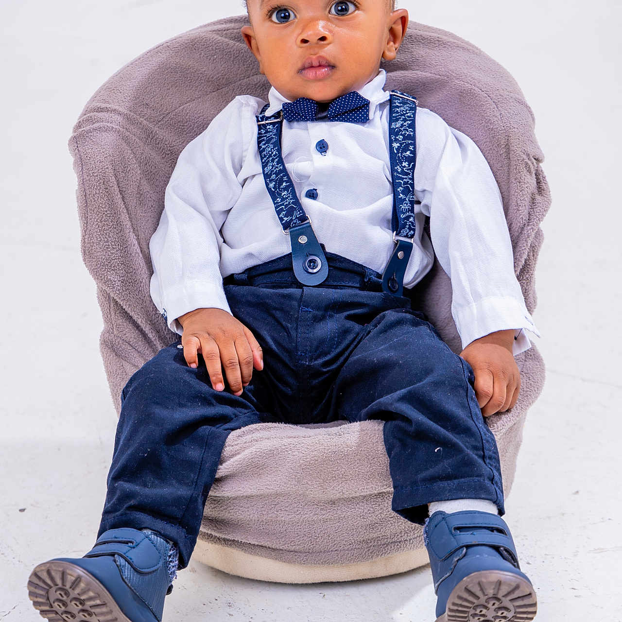 Yannick Blessing is registered to the contest to win money with this photo: accessories, boy, chair, child, clothing, face, footwear, formalwear, furniture, head, jeans, longsleeve, male, pants, person, photography, portrait, shoe, sitting, tie
