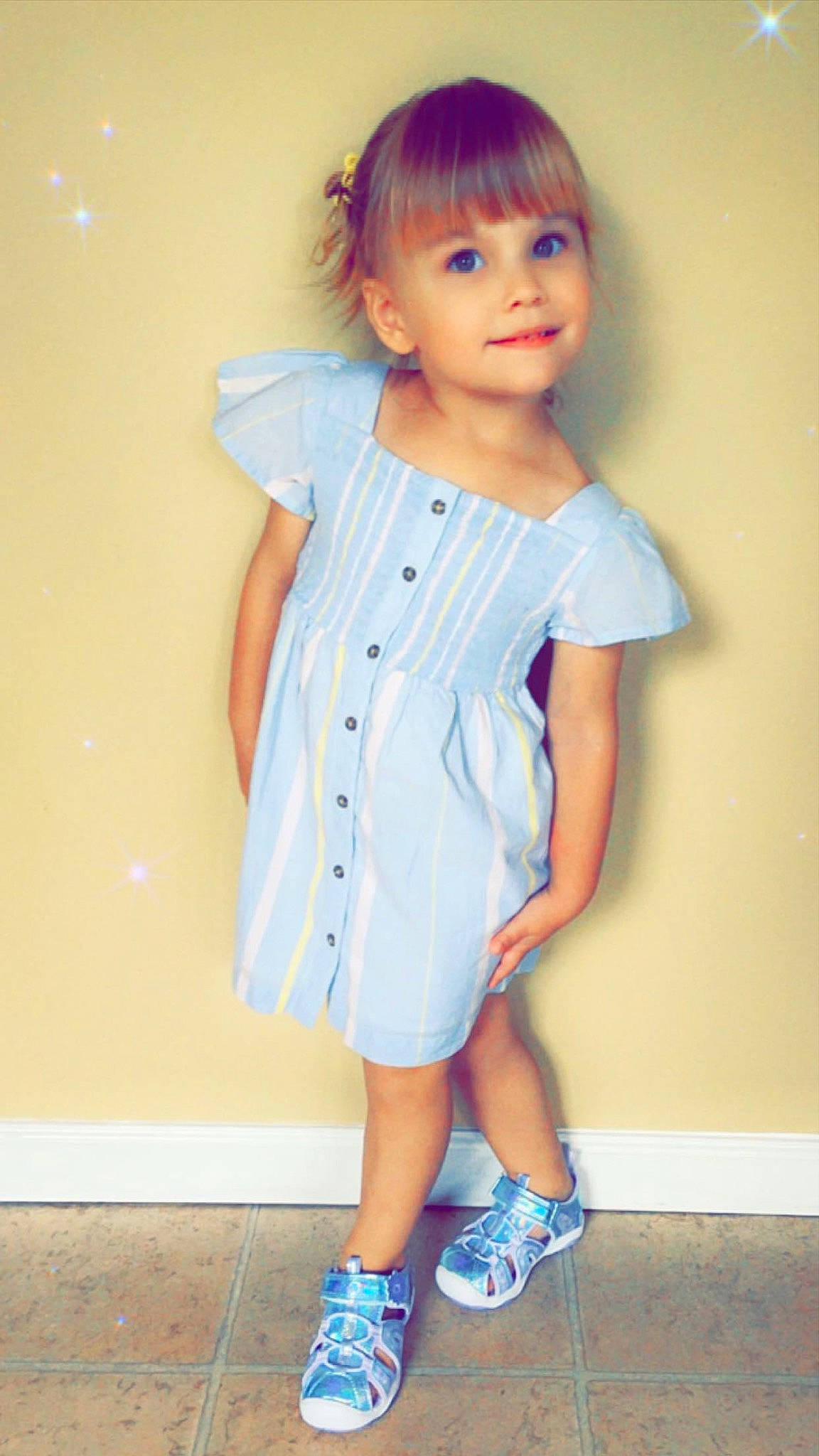 Liana is registered to the contest to win money with this photo: arm, baby_toddler_clothing, child, day_dress, dress, electric_blue, face, fashion_design, footwear, happy, joy, neck, one_piece_garment, pattern, person, skin, sleeve, smile, t_shirt, toddler