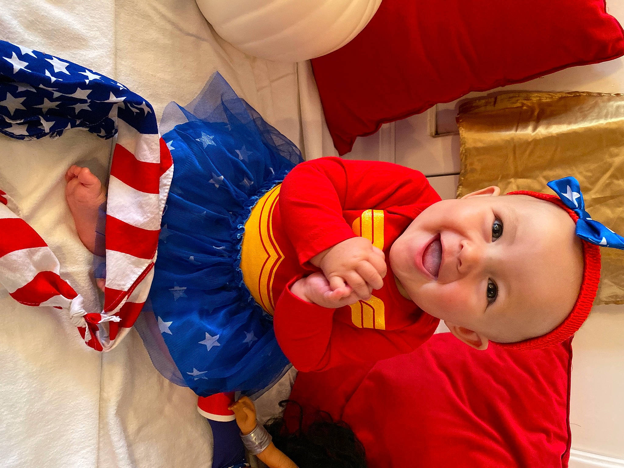 Remington is registered to the contest to win money with this photo: arm, baby_toddler_clothing, carmine, child, electric_blue, event, facial_expression, fictional_character, flag, flag_day_usa, flag_of_the_united_states, fun, gesture, happy, holiday, person, play, red, smile, textile