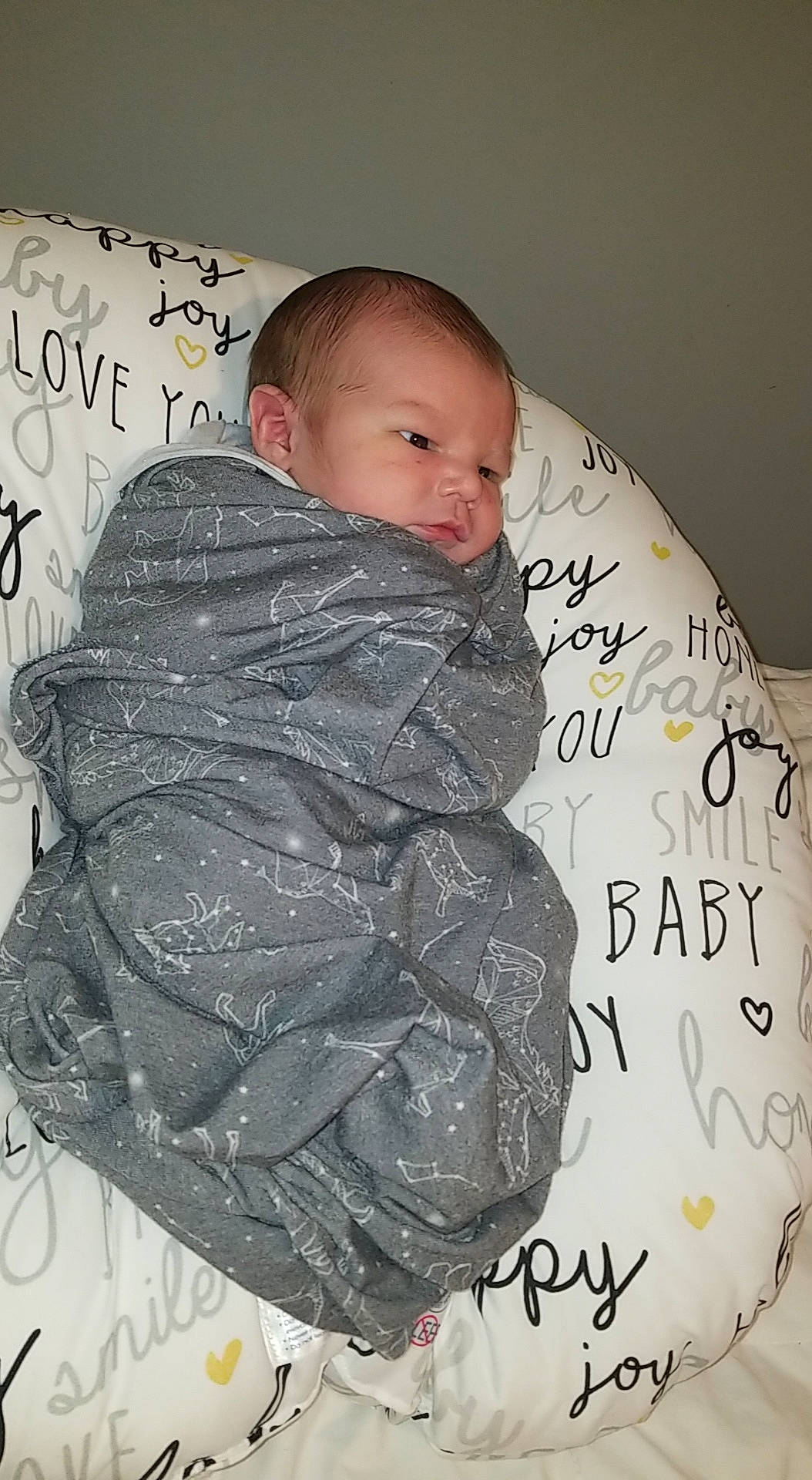 Cayde joined the competition — help win amazing prizes! baby, cheek, child, comfort, facial_expression, font, forehead, hairstyle, handwriting, happy, linens, neck, pattern, person, pink, product, sitting, sleeve, textile, thigh
