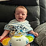 Casey joined the competition — help win amazing prizes! baby, infant, smiling, toy, mickey_mouse, donald_duck, striped_shirt, couch, blanket, cushion, indoor, happy, child, portrait, clothing, cute, sitting, leather, colorful, playtime