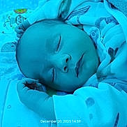 Maelle is registered to the contest to win money with this photo: baby, sleeping, infant, blanket, clothing, cozy, face, hand, peaceful, portrait, child, indoors, cute, soft_light, rest, newborn, closeup, babywear, sleep, toddler