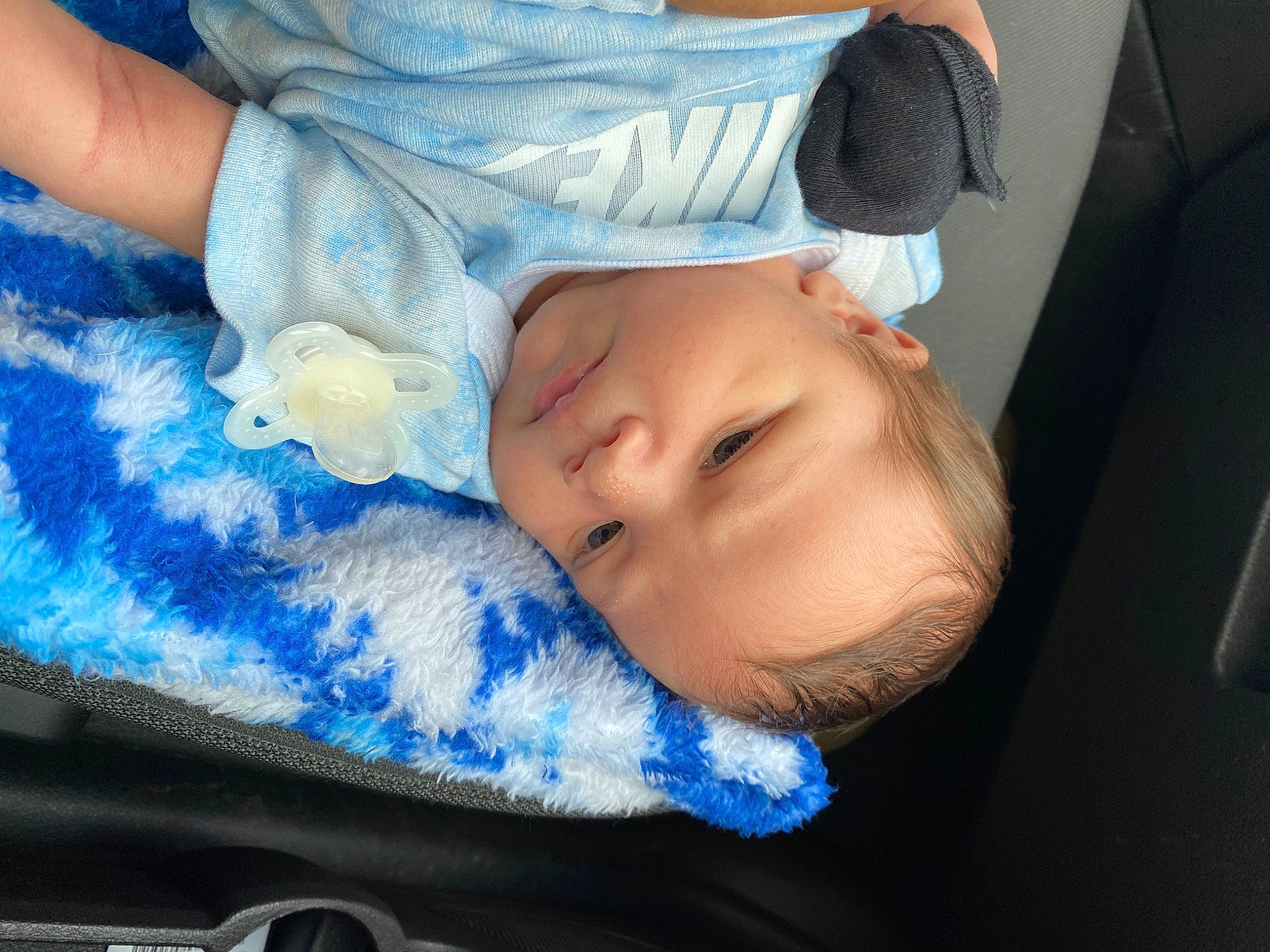 Cyrus is registered to the contest to win money with this photo: arm, baby, baby_products, baby_toddler_clothing, blue, cheek, child, comfort, electric_blue, eyelash, finger, happy, iris, linens, mouth, nail, nose, person, skin, thumb