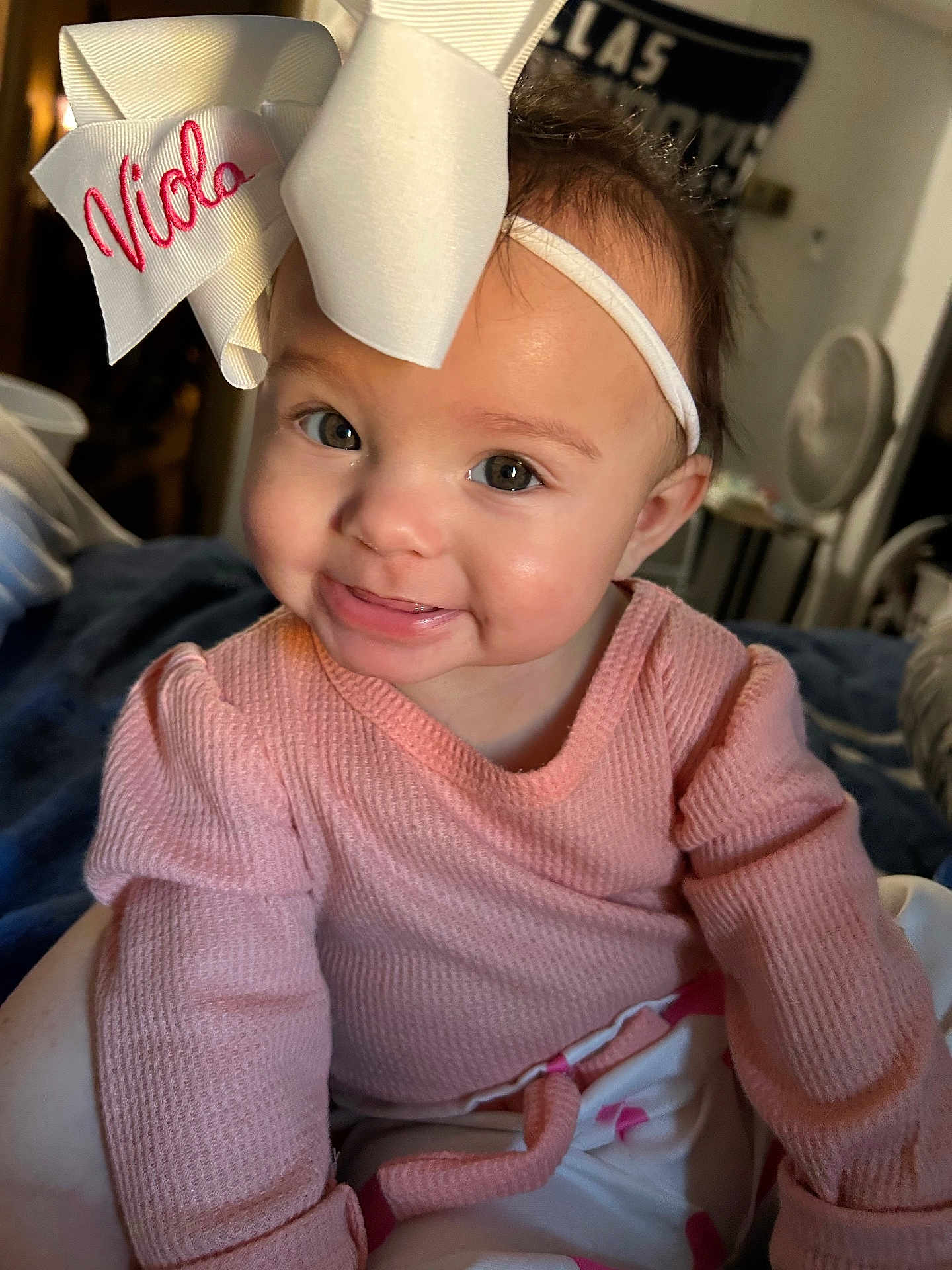 Viola joined the competition — help win amazing prizes! baby, child, smile, headband, bow, pink_sweater, indoor, portrait, cute, face, eyes, happy, infant, person, apparel, sitting, young_child, human, closeup, soft_lighting