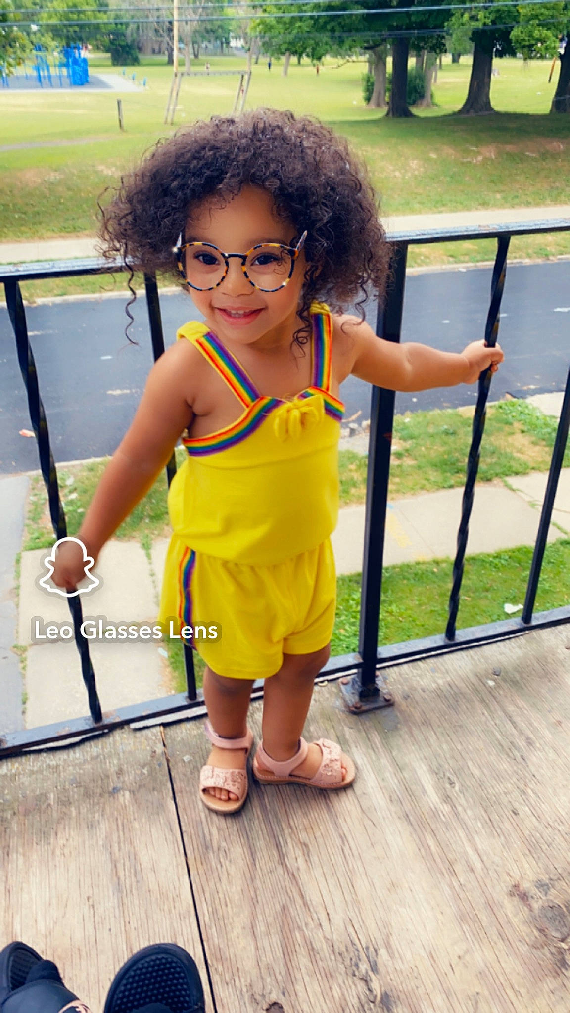 Kaylani Jimenez Perez is registered to the contest to win money with this photo: child, eyewear, flip_flops, flooring, foot, fun, glasses, grass, happy, human_leg, joy, leisure, person, plant, recreation, sandal, skin, thigh, toddler, vacation