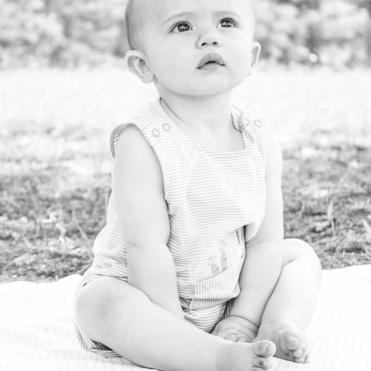 Coleson is registered to the contest to win money with this photo: arm, baby, bodypart, clothing, dress, face, finger, grass, hand, happy, head, pants, person, photography, plant, portrait, shorts, sitting, smile, t_shirt