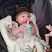 Cassandra joined the competition — help win amazing prizes! baby, bottle, blanket, hat, infant, child, cushion, seat, striped, bottle_feeding, cozy, pattern, clothing, cute, indoor, playful, young, feeding, smiling, portrait
