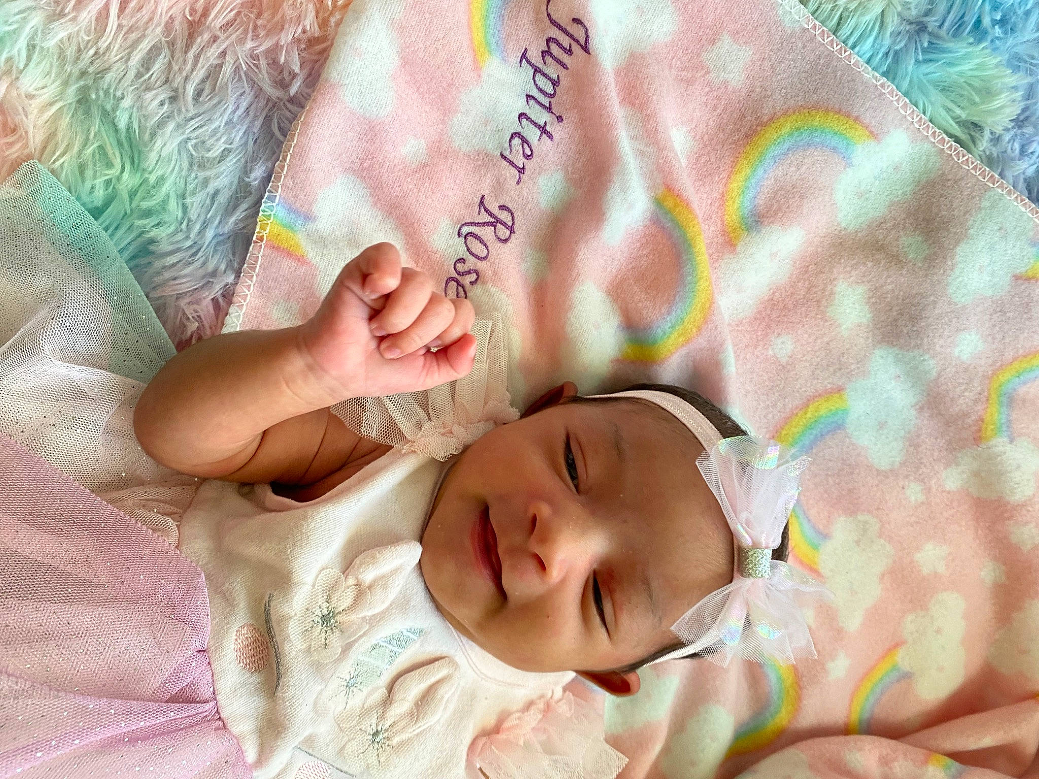 Jupiter is registered to the contest to win money with this photo: baby, baby_toddler_clothing, cheek, comfort, eyelash, face, gesture, grass, hand, happy, human_body, linens, lip, mouth, nose, pattern, person, pink, skin, textile