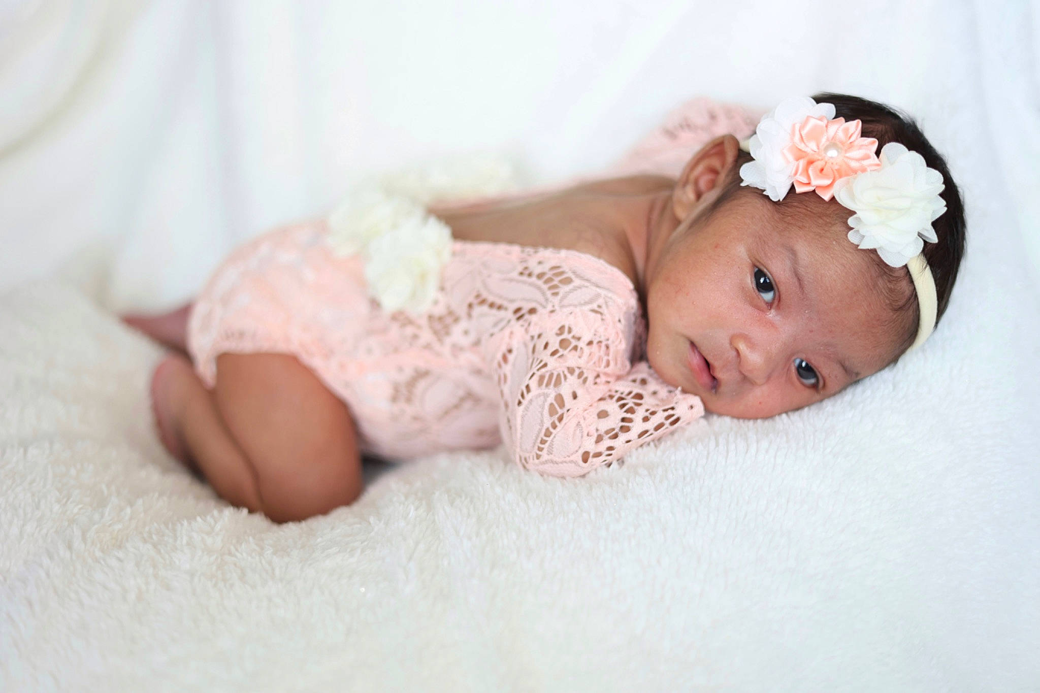 Jupiter is registered to the contest to win money with this photo: baby, baby_toddler_clothing, cheek, child, comfort, dress, flash_photography, flooring, grass, headband, headpiece, headwear, human_body, linens, lip, person, pink, skin, sleeve, textile